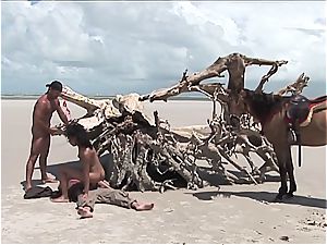 nasty latin doll gets 2 rods on the beach
