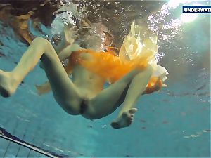 Yellow and red clad teenager underwater
